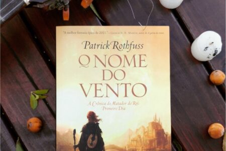 Livro O Nome do Vento em um fundo de madeira